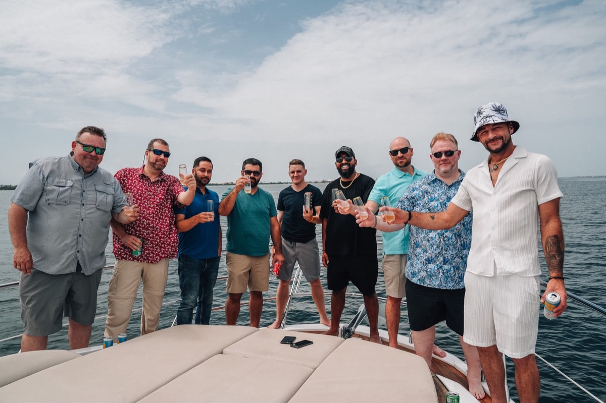 Lion's Den members together on a yacht